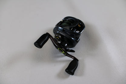 A used Daiwa Zillion SV TW JDM casting reel (9.1:1 gear ratio, black/metallic, two handles) in good condition is displayed on a plain white surface.
