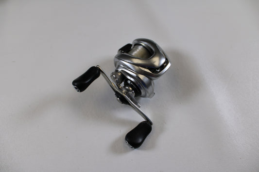 A Shimano Metanium MGL 150 XG 8.5:1 used casting reel in good condition is displayed on a plain white surface, ready to be offered through our Rod and Reel Trade-In Program.