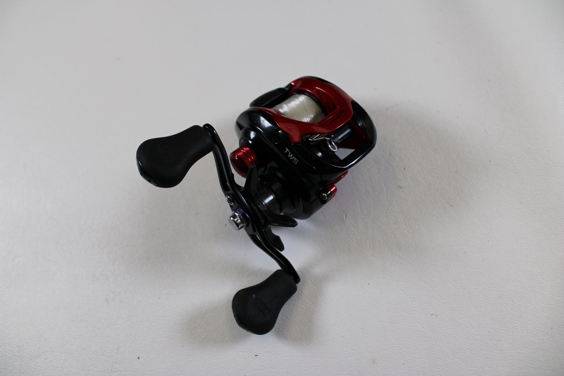 A Daiwa Tatula CT Type-R CT100XS 8.1:1 used casting reel in very good condition is displayed on a white surface—eligible for store credit when traded in through our Rod and Reel Trade-In Program.