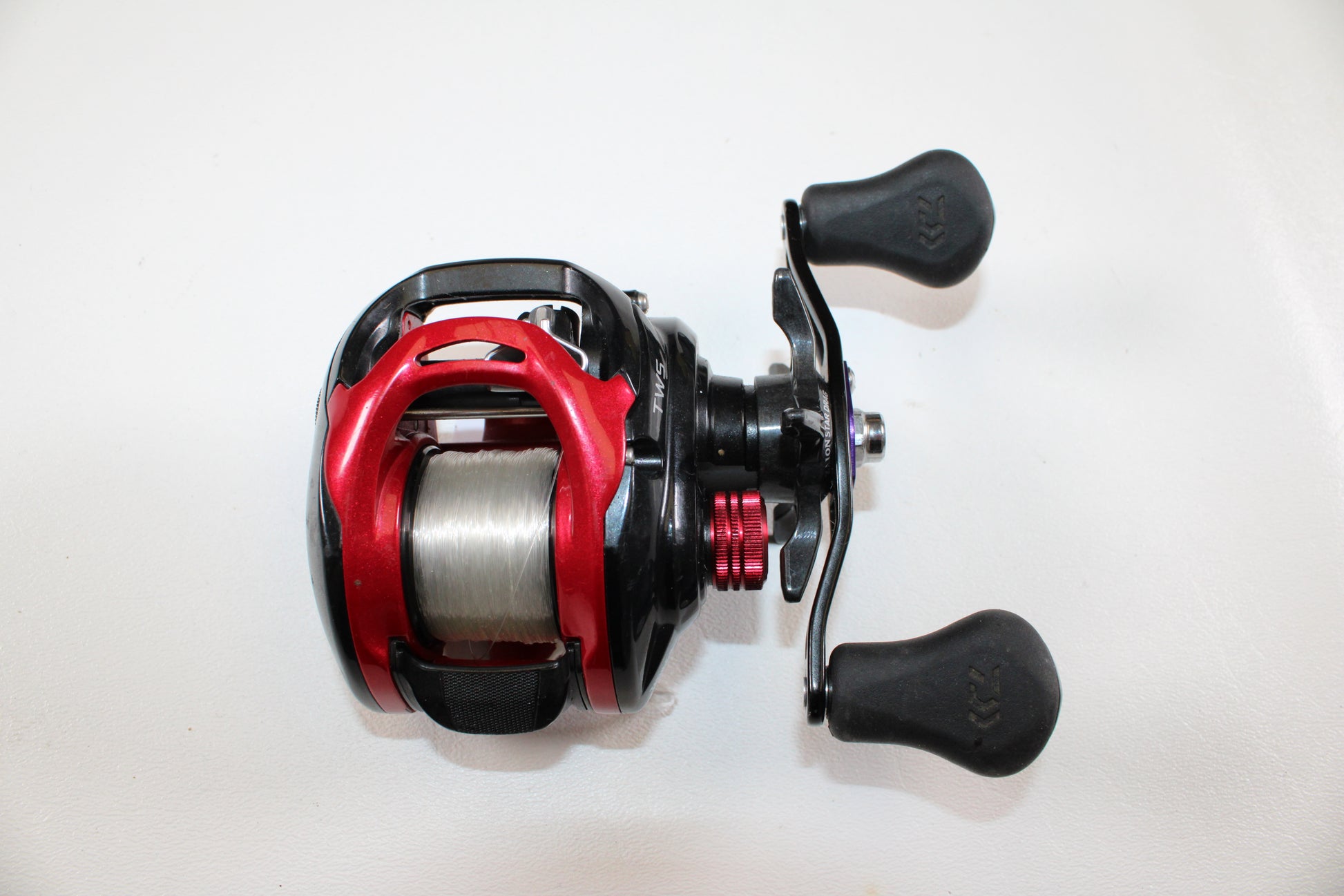 A close-up of a Daiwa Tatula CT Type-R CT100XS 8.1:1 gear ratio casting reel in very good used condition, shown with line on the spool against a white background—ideal for upgrading or shopping quality used Daiwa gear.