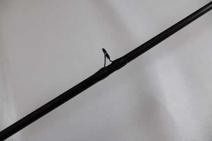 A close-up of the G. Loomis MBR844c IMX 7'0" Heavy - Used Casting Rod (Good Condition) highlights one of its guides against a plain white background.
