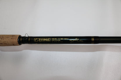 A close-up of a G. Loomis FGR863 7'2" Medium Heavy Used Casting Rod in good condition, featuring a cork handle and fast action—ideal for quality gear seekers or those interested in our rod and reel trade-in program.
