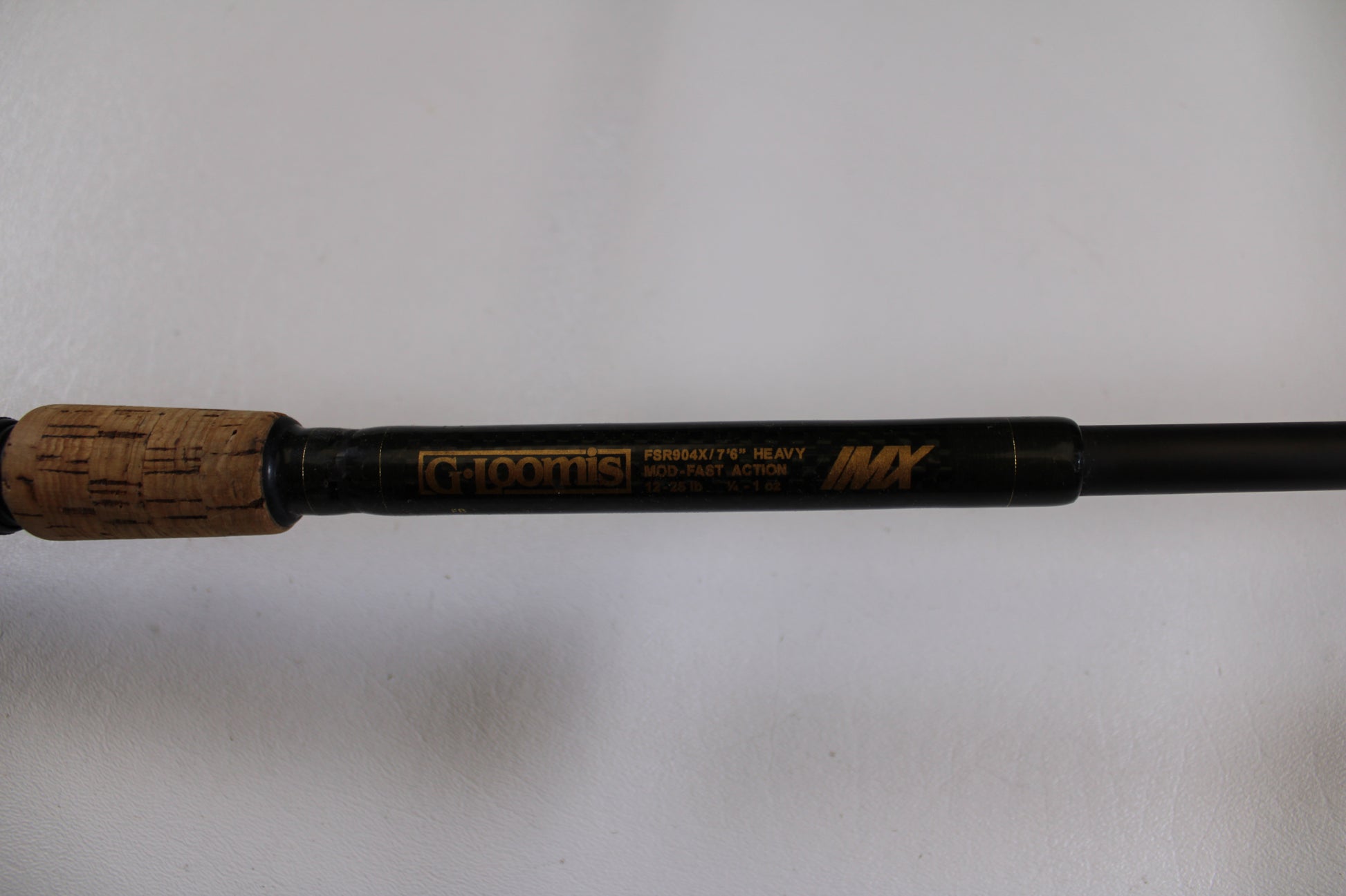 Close-up of the G. Loomis FSR904X IMX 7'6" Heavy Used Casting Rod with cork handle, in good condition. Eligible for our Rod & Reel Trade-In—exchange your used gear for store credit today!.