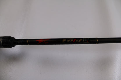 A close-up of a Falcon Cara T7 CC-5-167S Weightless Worm Used Casting Rod in good condition, displaying gold and red accents on black. Trade in your old rod through our program to upgrade and earn store credit.