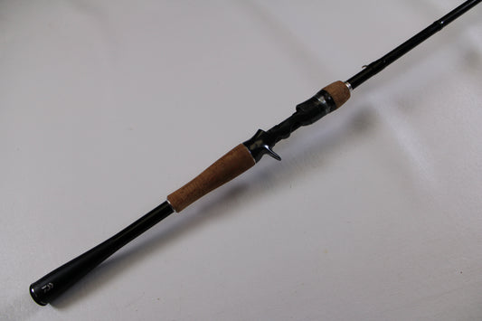 The Daiwa Zillion ZLON721HFB 7'2" Heavy Used Casting Rod, in excellent condition, features a black finish, cork handles, and baitcasting reel seat—perfect for those considering used gear or using our rod and reel trade-in program.