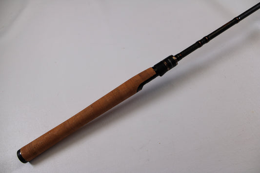 A close-up of the Dobyns Champion Extreme HP DX743SF Used Spinning Rod’s cork handle and black reel seat—an ideal choice for those looking to trade in used gear for store credit through our Rod and Reel Trade-In Program.