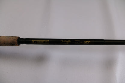 Close-up of the G. Loomis BCFR894 GLX used casting rod in good condition, featuring gold model details on a dark shaft with cork grip—ideal for upgrading your gear through our rod and reel trade-in program for store credit.