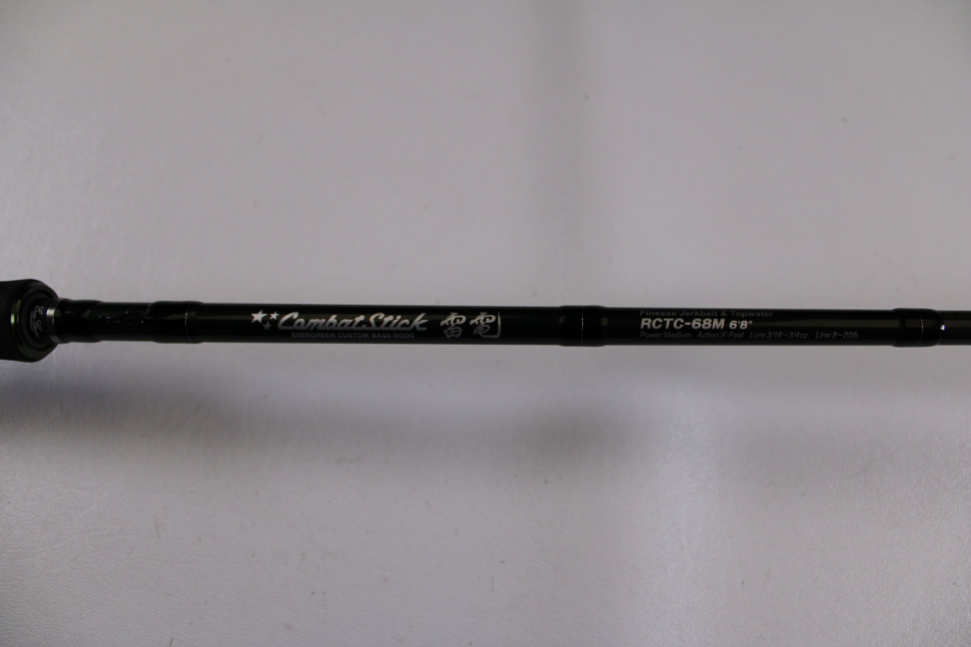 A close-up of the Evergreen Combat Stick RCTC-68M, a used casting rod in excellent condition, shows its model details and "Combat Stick" text on the shaft against a white background—ideal for our Rod and Reel Trade-In Program.