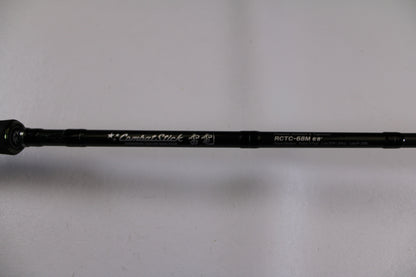 A close-up of the Evergreen Combat Stick RCTC-68M, a used casting rod in excellent condition, shows its model details and "Combat Stick" text on the shaft against a white background—ideal for our Rod and Reel Trade-In Program.