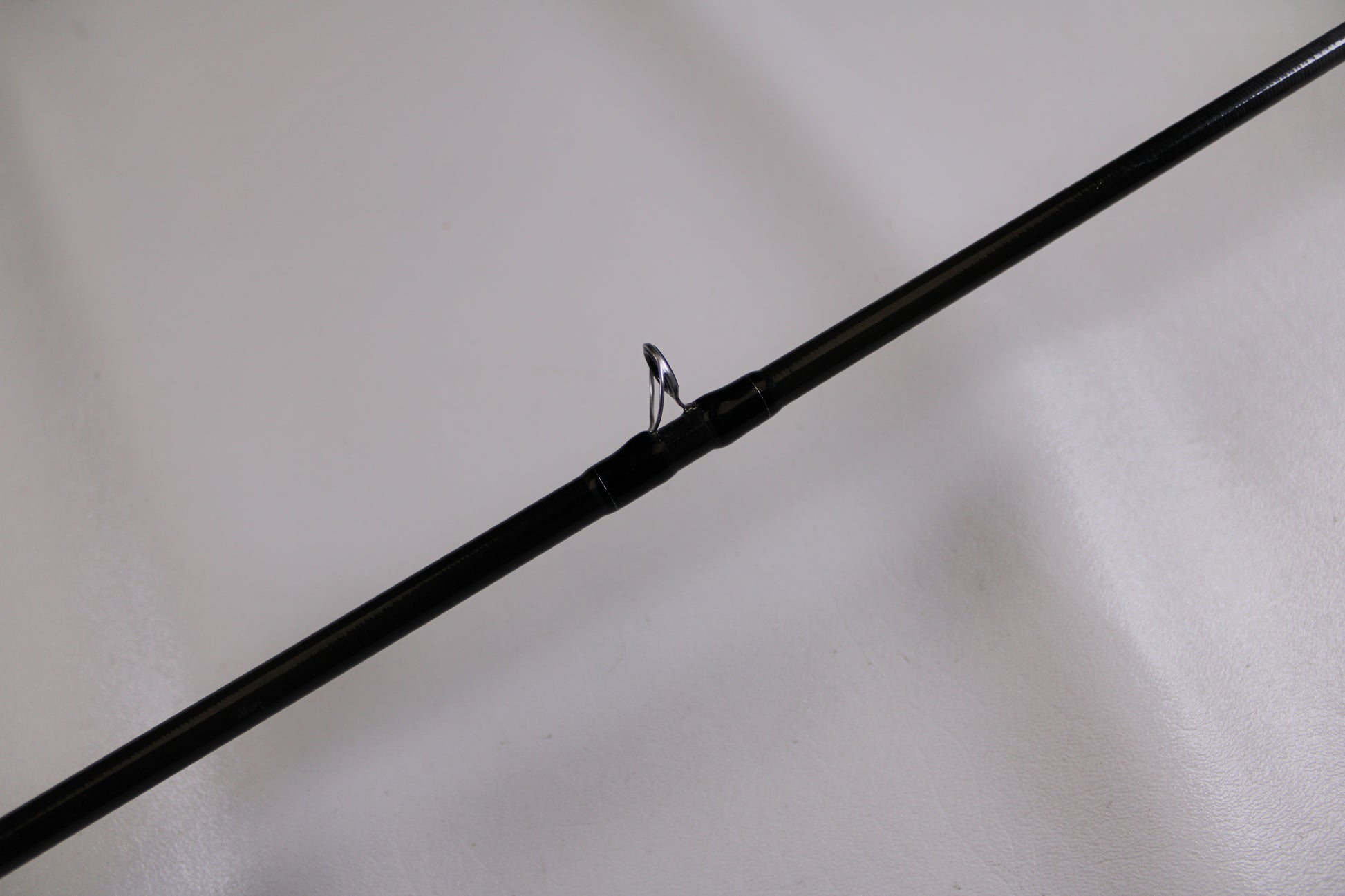 A close-up of the Evergreen Combat Stick RCTC-68M, a used casting rod in excellent condition, highlights its line guide—ideal for anyone seeking quality pre-owned gear or considering our Rod and Reel Trade-In Program.
