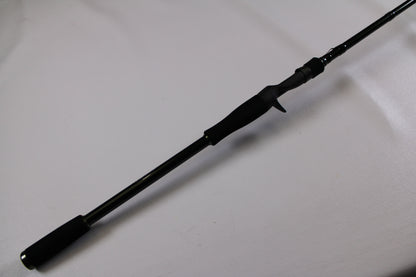 A close-up of the Evergreen Combat Stick RCTC-78XH used casting rod handle with trigger grip, shown diagonally on a white surface. Excellent condition—ideal for the Rod and Reel Trade-In Program.