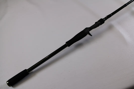 A close-up of the Evergreen Combat Stick RCTC-78XH used casting rod handle with trigger grip, shown diagonally on a white surface. Excellent condition—ideal for the Rod and Reel Trade-In Program.