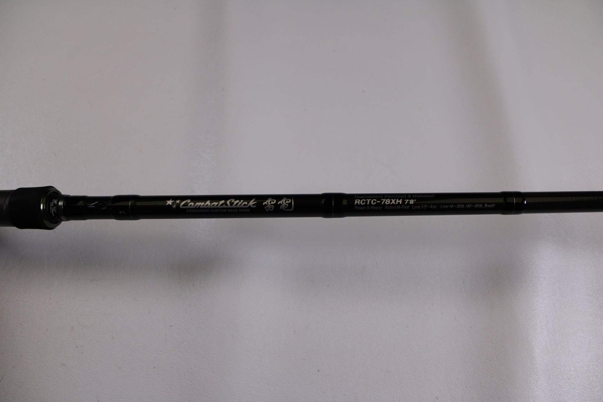 A close-up of an Evergreen Combat Stick RCTC-78XH Used Casting Rod in excellent condition, ideal for the Rod and Reel Trade-In Program or adding to your used gear collection. The black rod is set against a plain white background.
