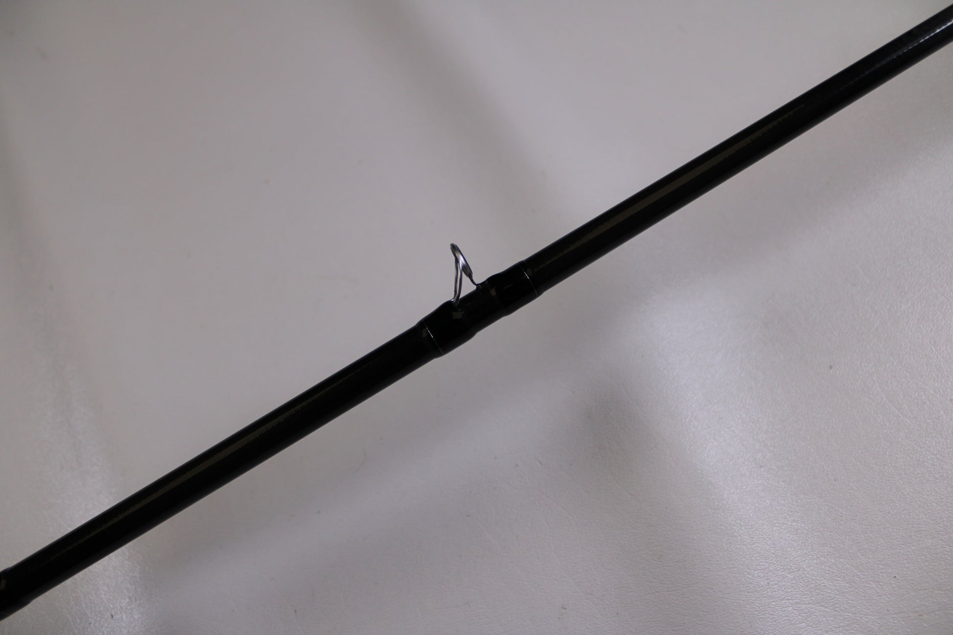 A close-up of the Evergreen Combat Stick RCTC-78XH—Used Casting Rod in excellent condition, featuring a metal guide ring against a plain white background—ideal for those trading in used gear for store credit or the Rod and Reel Trade-In Program.