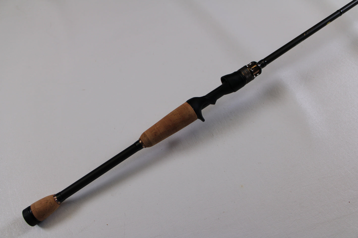 The Megabass Destroyer P5 F4-66X Used Casting Rod (Excellent Condition) features cork handles and a black reel seat, pictured diagonally on a white background. Trade in your used gear for store credit with our Rod and Reel Trade-In Program!.