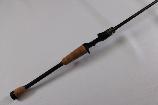 The Megabass Destroyer P5 F4-66X Used Casting Rod (Excellent Condition) features cork handles and a black reel seat, pictured diagonally on a white background. Trade in your used gear for store credit with our Rod and Reel Trade-In Program!.