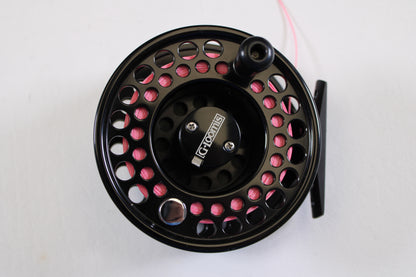 A close-up of the G. Loomis GL 8-9-10 with Spare Spool—Used Fly Reel in excellent condition, wound with pink line on a white background, ideal for upgrade via our Rod and Reel Trade-In Program for store credit or used gear.