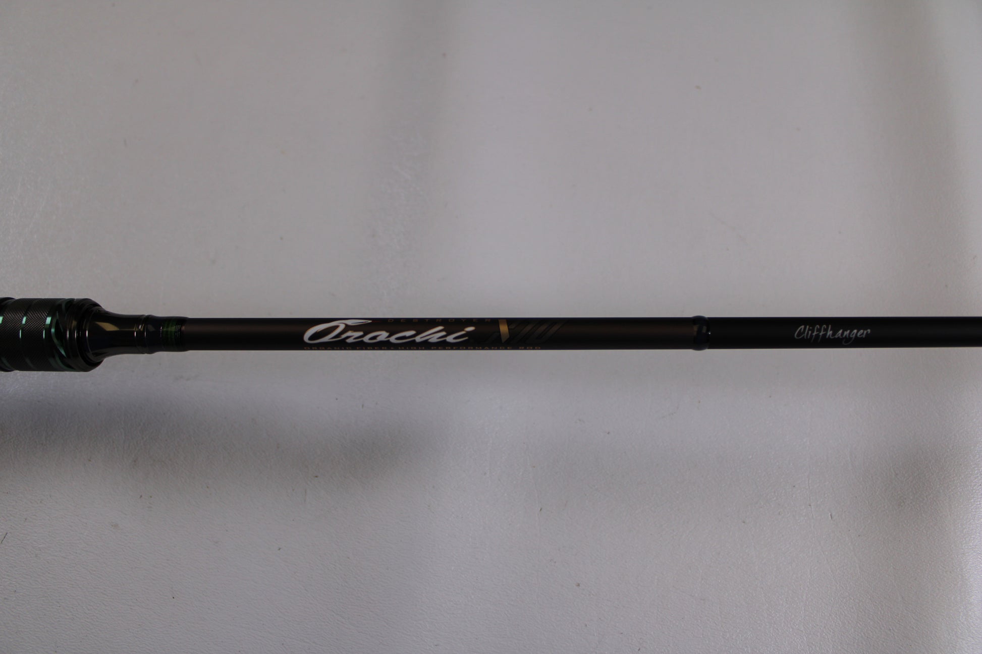 A close-up of the Megabass Orochi X10 F1.1/2-65XT Cliffhanger Used Casting Rod in excellent condition, featuring "Orochi" and "CHT Layer" on the shaft—ideal for used gear buyers or our Rod and Reel Trade-In program.