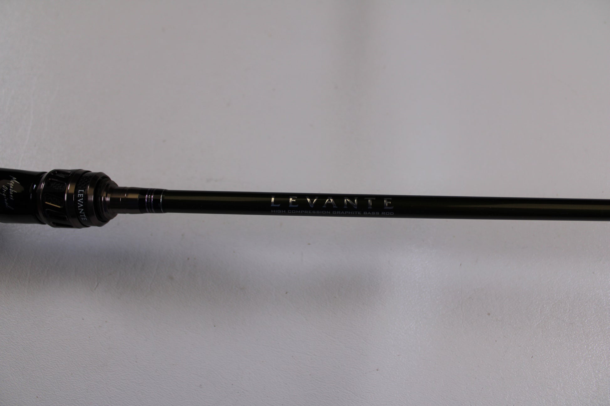 A close-up of the Megabass Levante F3-66LV Used Casting Rod in excellent condition, featuring "LEVANTE" on the shaft—ideal for those interested in quality used gear from our Rod and Reel Trade-In program.