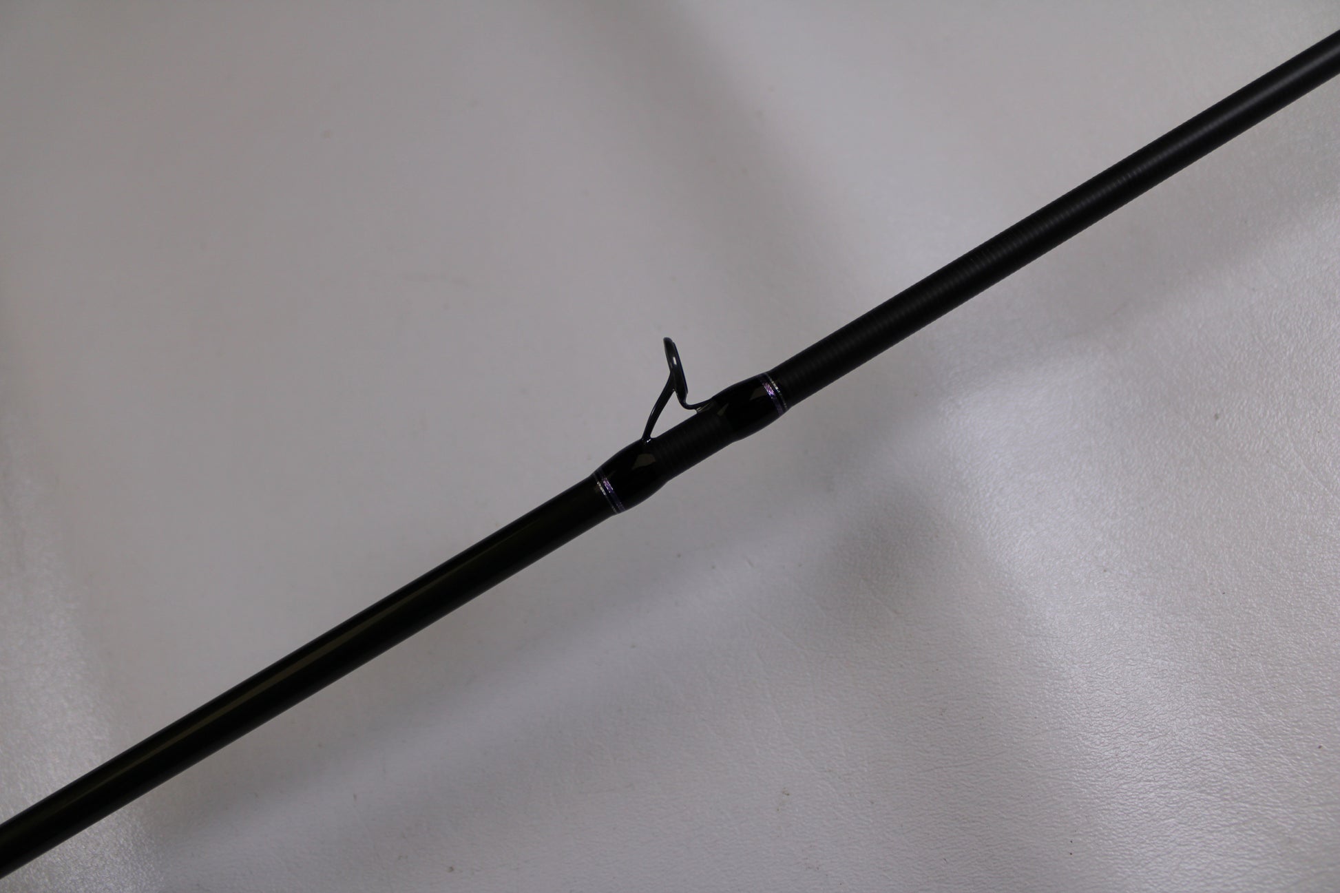 A close-up of the Megabass Levante F3-66LV Used Casting Rod in excellent condition, showing a line guide against a light background—ideal for those interested in used Megabass gear for a Rod and Reel Trade-In Program.