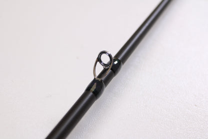 A close-up of the Megabass Destroyer P5 F2.1/2-611X Kasumi Six Eleven 6'11" Medium Light Used Casting Rod in excellent condition, perfect for anglers looking to trade in gear for store credit with our program.