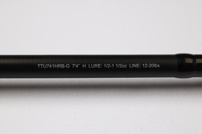 A close-up of the Daiwa Tatula TTU741HRB-G 7'4" Heavy Glass Used Casting Rod shows its specs in white text on a black rod, ideal for our Rod and Reel Trade-In Program if you're upgrading your used Daiwa gear.