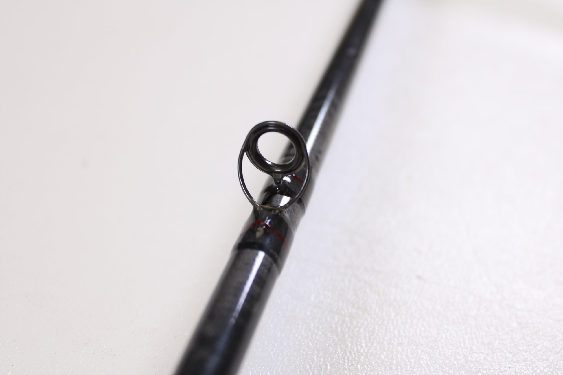 Close-up of a St. Croix Victory VTC68MXF The Jerk 6'8" Medium used casting rod in very good condition, black finish with a guide ring—ideal for those seeking quality pre-owned gear from St. Croix.