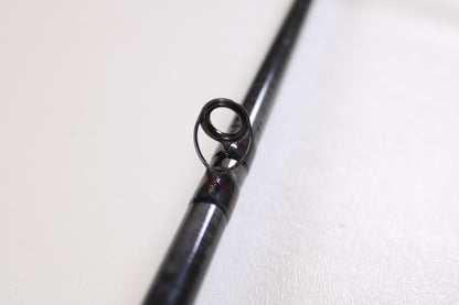 Close-up of a St. Croix Victory VTC68MXF The Jerk 6'8" Medium used casting rod in very good condition, black finish with a guide ring—ideal for those seeking quality pre-owned gear from St. Croix.