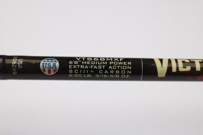 Close-up of St. Croix Victory VTS68MXF Tactical 6'8" Medium Spinning Rod label: extra-fast action, SCIII+ carbon, 6-20 lb line, 3/16-5/8 oz lure weight. USA emblem at left—eligible for our Trade-In Program for store credit on used gear.