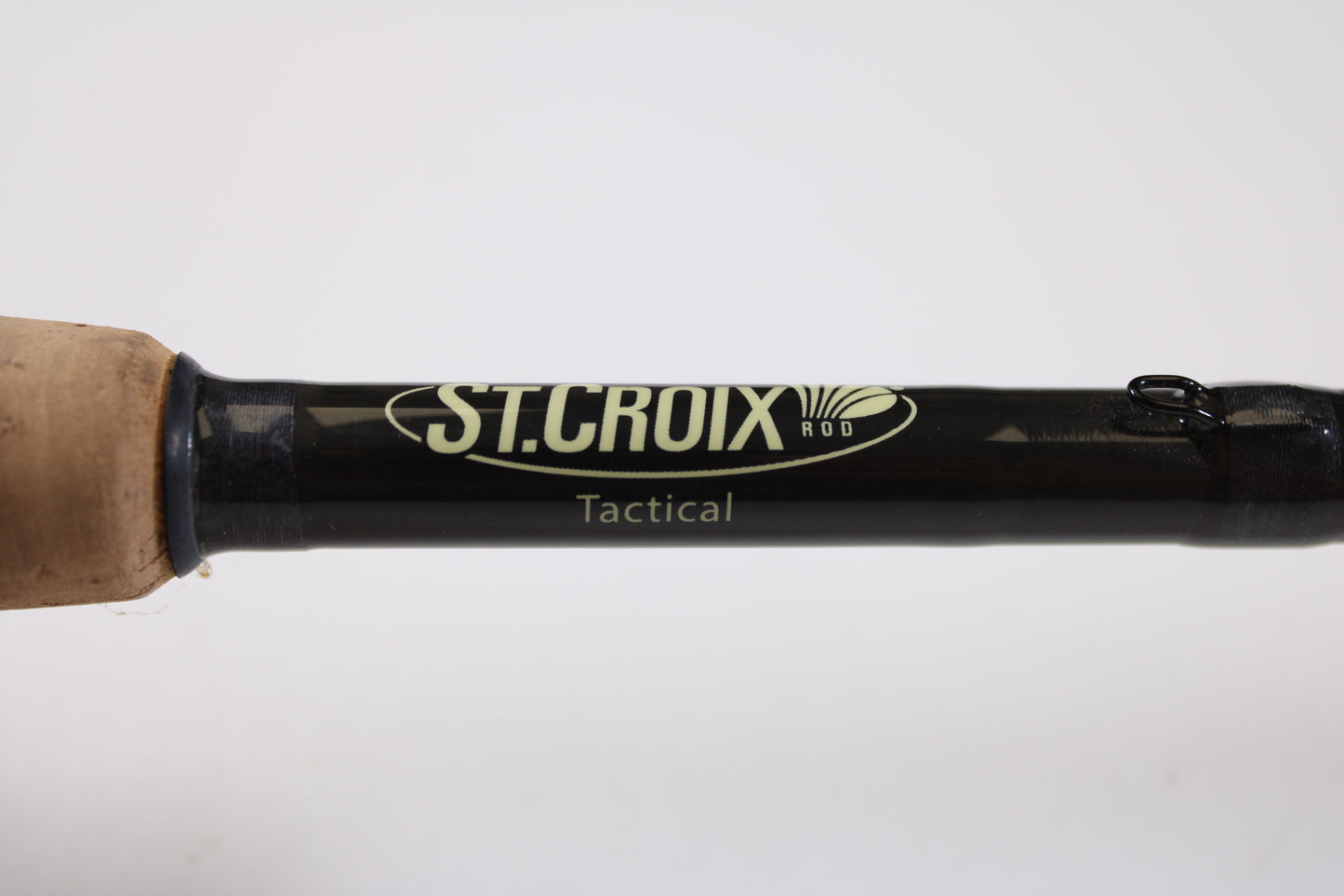 Close-up of a St. Croix Victory VTS68MXF Tactical 6'8" Medium used spinning rod in excellent condition, featuring the brand label on its black shaft and a cork handle—ideal for the Rod and Reel Trade-In Program or store credit on used gear.