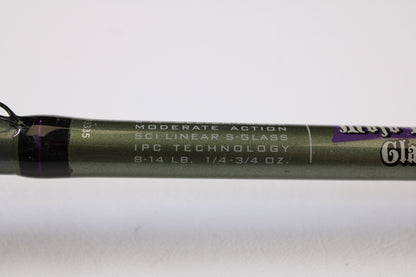 Close-up of a St. Croix Mojo Bass MGC610MM Target Cranker 6'10" Medium Used Casting Rod in excellent condition, showing "MODERATE ACTION, SCII LINEAR S-GLASS, IPC TECHNOLOGY, 8-14 LB., 1/4-3/4 OZ." on olive green rod.