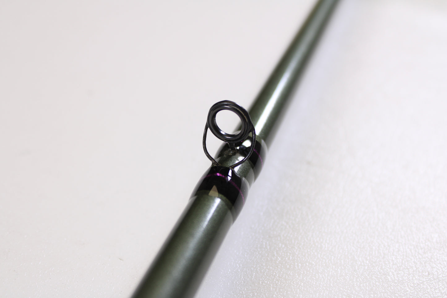Close-up of a St. Croix Mojo Bass MGC610MM Target Cranker 6'10" Medium Used Casting Rod in excellent condition, with a black guide ring visible against a white background—ideal for used gear enthusiasts or trade-in program participants.