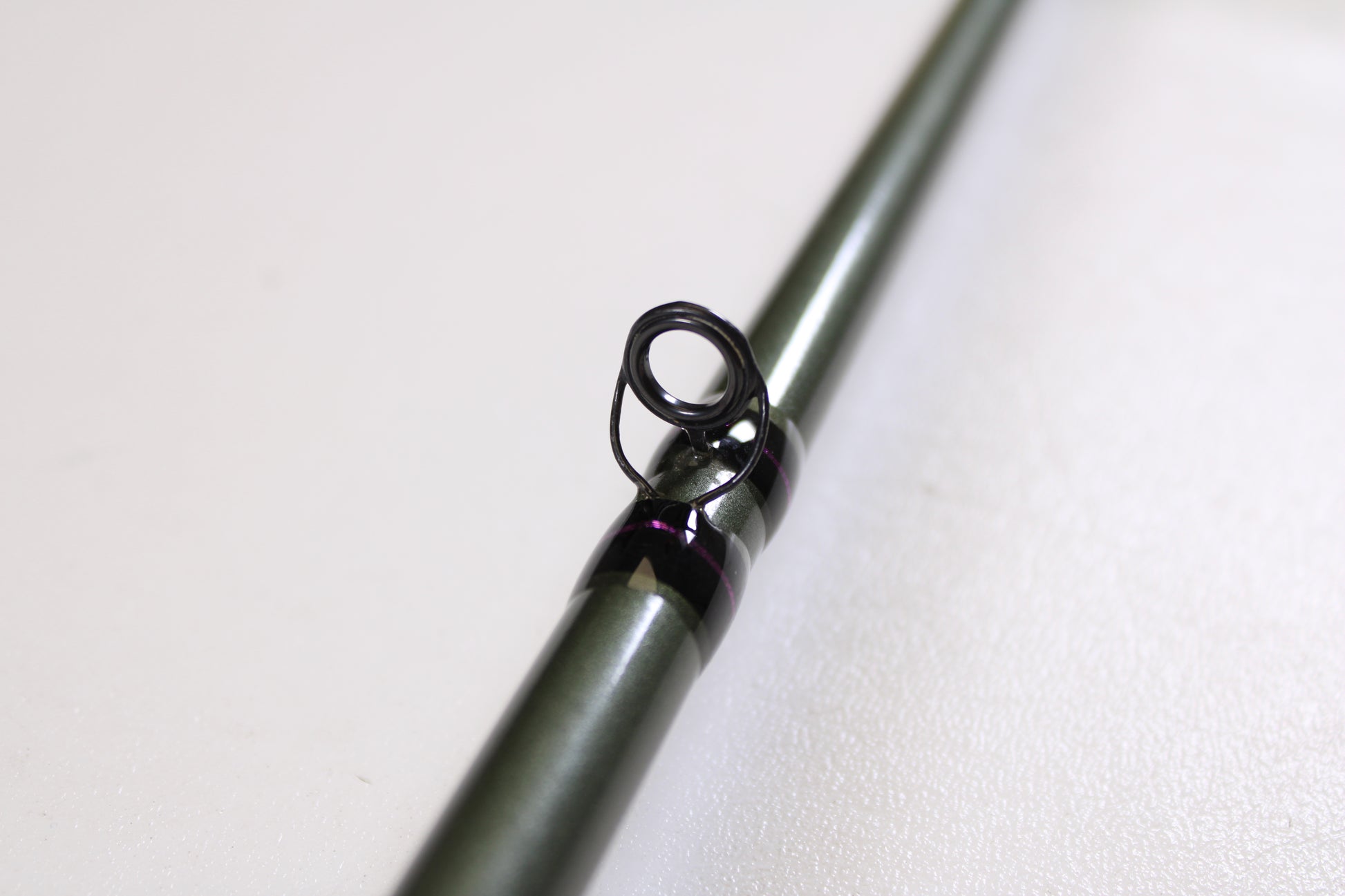 Close-up of a St. Croix Mojo Bass MGC610MM Target Cranker 6'10" Medium Used Casting Rod in excellent condition, with a black guide ring visible against a white background—ideal for used gear enthusiasts or trade-in program participants.