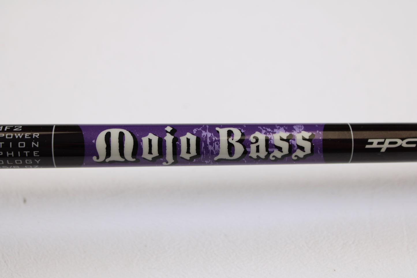 A close-up of a St. Croix Mojo Bass MJC71MF2 7'1" Medium Used Casting Rod in excellent condition, labeled in bold white letters on a purple background. Eligible for trade-in credit through the Rod and Reel Trade-In Program.