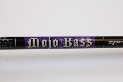 A close-up of a St. Croix Mojo Bass MJC71MF2 7'1" Medium Used Casting Rod in excellent condition, labeled in bold white letters on a purple background. Eligible for trade-in credit through the Rod and Reel Trade-In Program.
