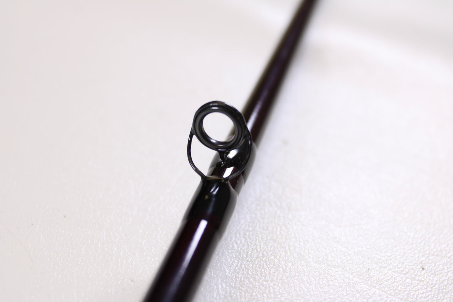 Close-up of the circular metal guide on a St. Croix Mojo Bass MJC71MF2 Plastics 7'1" Medium 2 Piece - Used Casting Rod (Excellent Condition) against a light background—ideal for our Rod and Reel Trade-In Program.