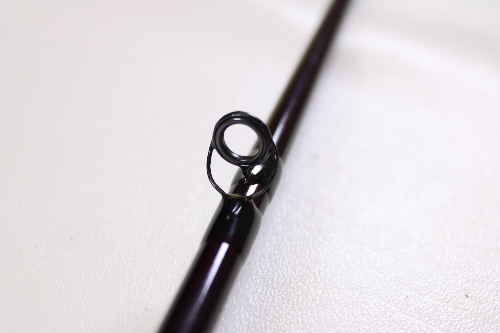 Close-up of the circular metal guide on a St. Croix Mojo Bass MJC71MF2 Plastics 7'1" Medium 2 Piece - Used Casting Rod (Excellent Condition) against a light background—ideal for our Rod and Reel Trade-In Program.