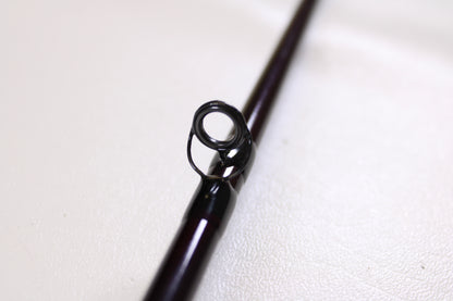 Close-up of the circular metal guide on a St. Croix Mojo Bass MJC71MF2 Plastics 7'1" Medium 2 Piece - Used Casting Rod (Excellent Condition) against a light background—ideal for our Rod and Reel Trade-In Program.