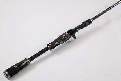 The Evergreen International Combat Stick RCSC-71M Jerkbait & Squarebill 7'1" Medium Used Casting Rod, in very good condition, features a camouflage-patterned handle and black accents. Trade in your old gear for store credit toward this modern rod.