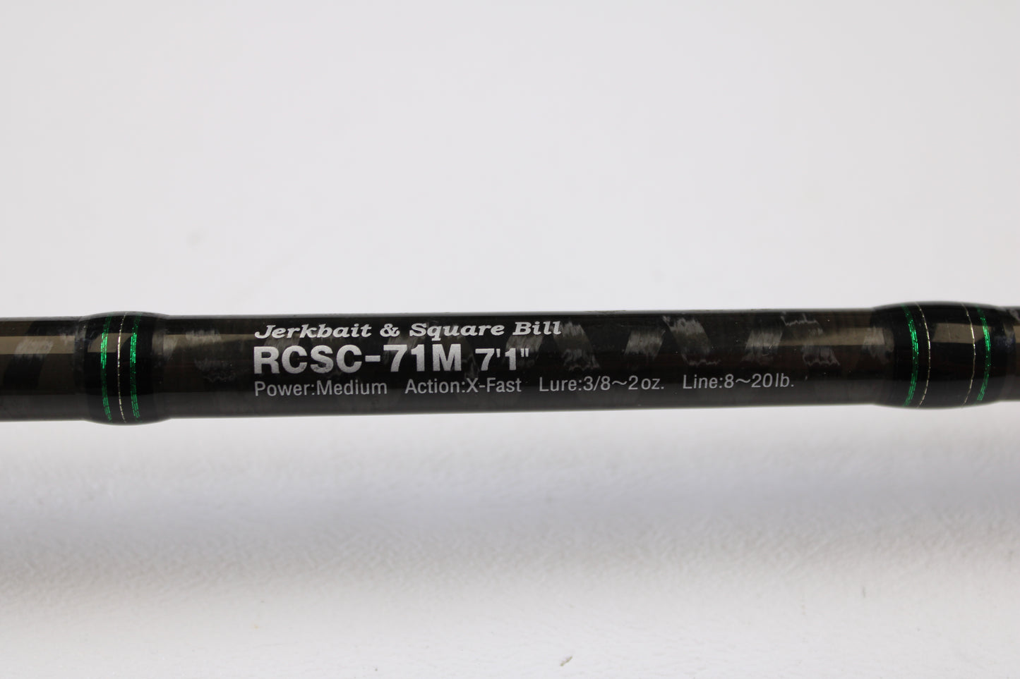 A close-up of the Evergreen Combat Stick RCSC-71M Jerkbait & Squarebill 7'1" Medium Used Casting Rod—ideal for our Rod and Reel Trade-In Program—shows its sleek black design, green accents, and white model text; condition is very good.