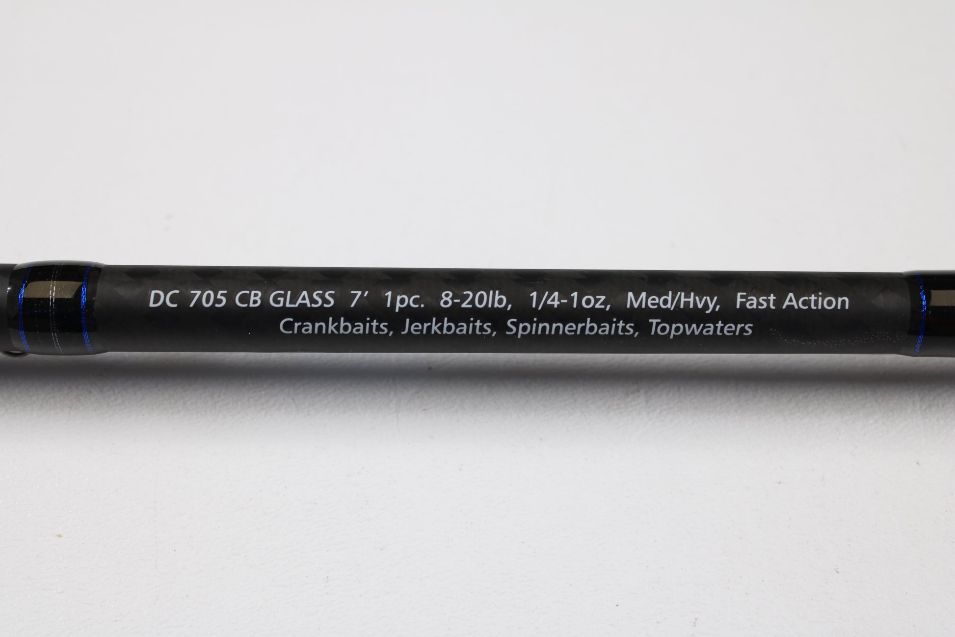 A close-up of the Dobyns Champion XP DC705CBGLASS 7'0" Medium Heavy Glass Casting Rod (Used, Excellent Condition) shows specs in white on black—trade up with our Rod and Reel Trade-In Program for store credit on your next Dobyns purchase.