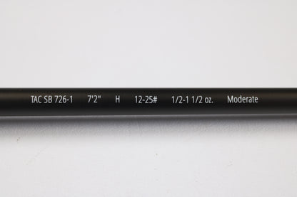 Close-up of a Temple Fork TFO Tactical Bass TACSB726-1 7'2" Heavy used casting rod in excellent condition, displaying its specs on the blank. Great for anglers seeking quality used gear or our rod and reel trade-in. Photographed on white background.