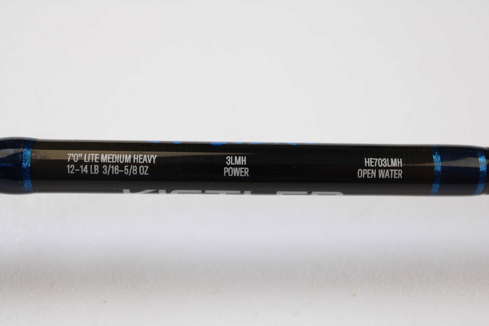 A close-up of a Kistler Helium HE703LMH 7’0” Lite Medium Heavy Used Casting Rod, in excellent condition, part of our Rod and Reel Trade-In Program. “12-14 LB, 3/16-5/8 OZ, 3LMH POWER” specs and blue accents are visible on this quality Kistler gear.