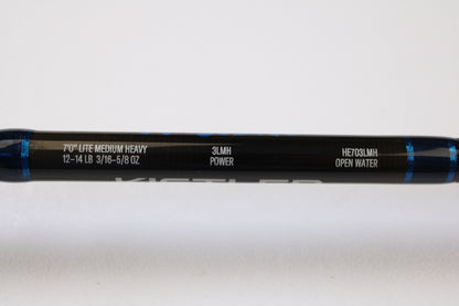 A close-up of a Kistler Helium HE703LMH 7’0” Lite Medium Heavy Used Casting Rod, in excellent condition, part of our Rod and Reel Trade-In Program. “12-14 LB, 3/16-5/8 OZ, 3LMH POWER” specs and blue accents are visible on this quality Kistler gear.