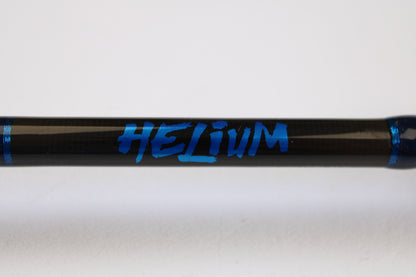 A close-up of a Kistler Helium HE703LMH 7'0" Lite Medium Heavy Used Casting Rod in excellent condition, featuring bold blue "HELIUM" graphics and blue bands—ideal for upgrading via our Rod & Reel Trade-In Program for store credit.