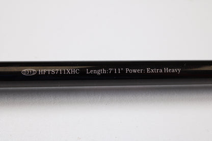 A close-up of the Halo Twilite HFTS711XHC 7'11" Extra Heavy Used Casting Rod in excellent condition shows white text on a black rod and an oval marked 0313—ideal for our rod and reel trade-in program.