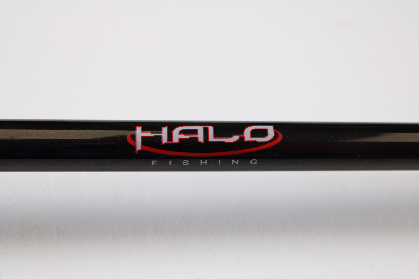 A close-up of a Halo Twilite HFTS711XHC 7'11" Extra Heavy Used Casting Rod in excellent condition shows "HALO" in red and "FISHING" in white on the blank—ideal for those interested in our rod and reel trade-in program for store credit.