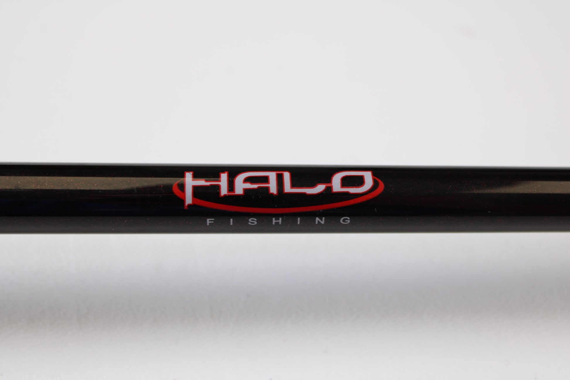 A close-up of a Halo Twilite HFTS711XHC 7'11" Extra Heavy Used Casting Rod in excellent condition shows "HALO" in red and "FISHING" in white on the blank—ideal for those interested in our rod and reel trade-in program for store credit.