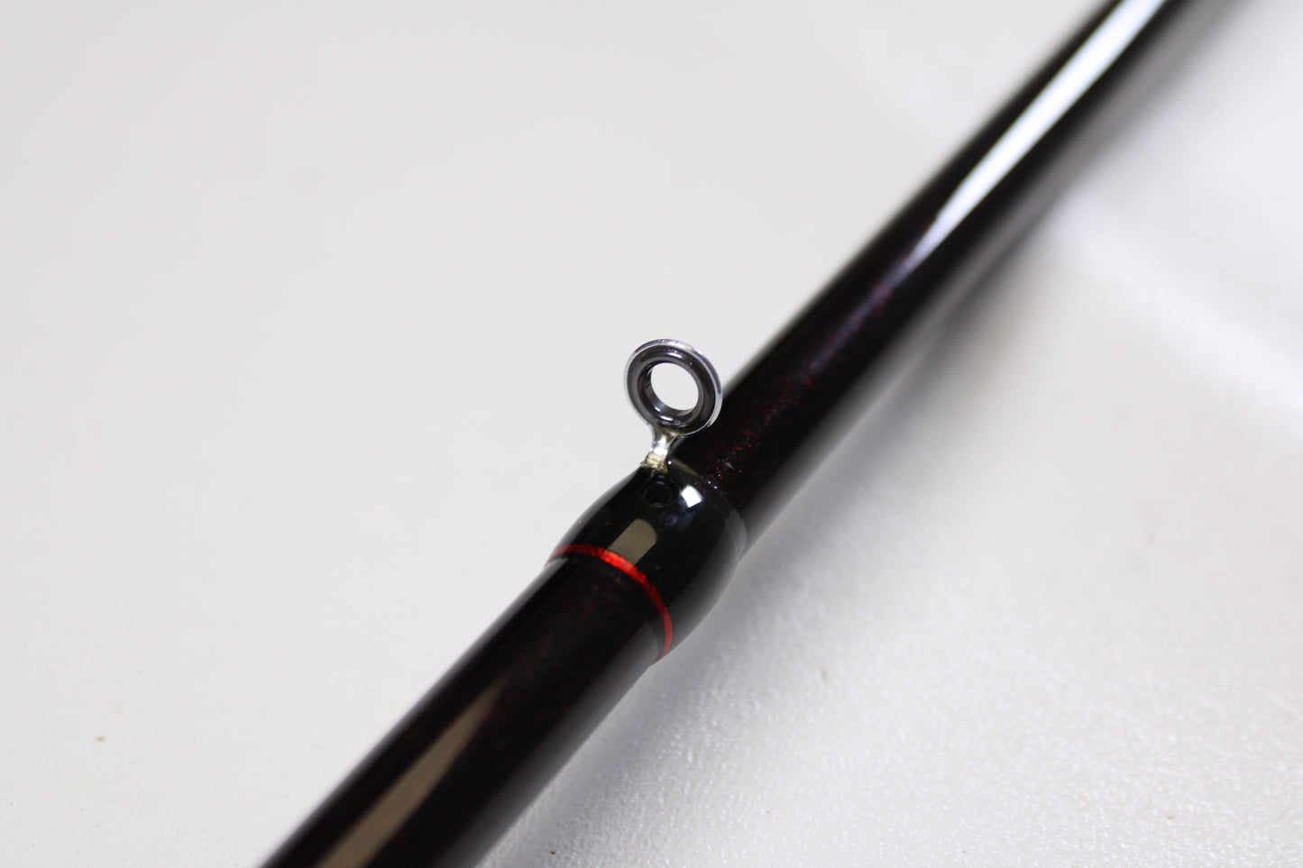 Close-up of the Halo Twilite HFTS711XHC 7'11" Extra Heavy Used Casting Rod in excellent condition, featuring a black finish, metal guide ring, and red accent—ideal for upgrades through our rod and reel trade-in program.