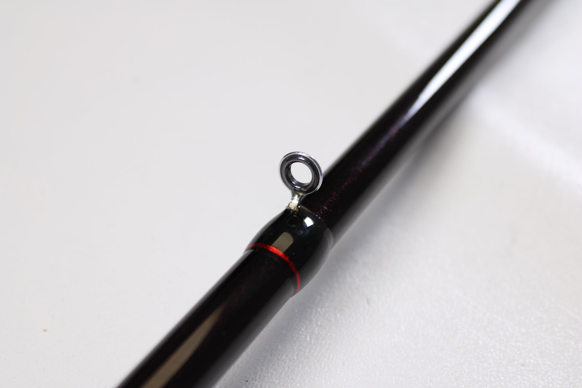 Close-up of the Halo Twilite HFTS711XHC 7'11" Extra Heavy Used Casting Rod in excellent condition, featuring a black finish, metal guide ring, and red accent—ideal for upgrades through our rod and reel trade-in program.